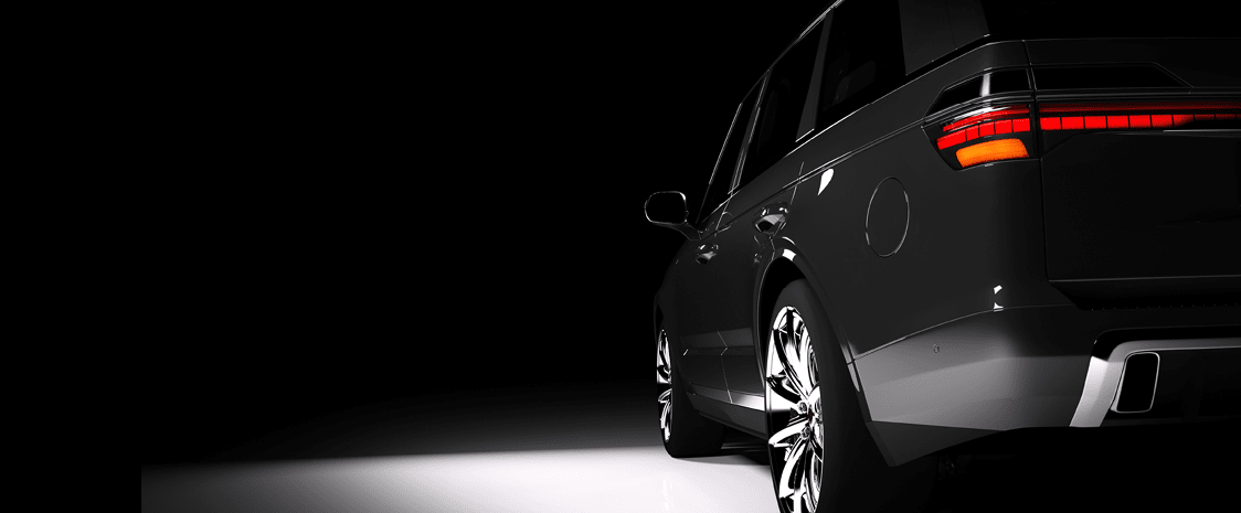 Back view of modern black SUV car in a spotlight on a black background. 3D render. Luxury cars.