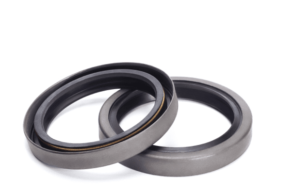 Two rubber reinforced oil seals for shafts and for car motor engines, isolated on white background. Cuffs for prevent liquid leak. Car parts.